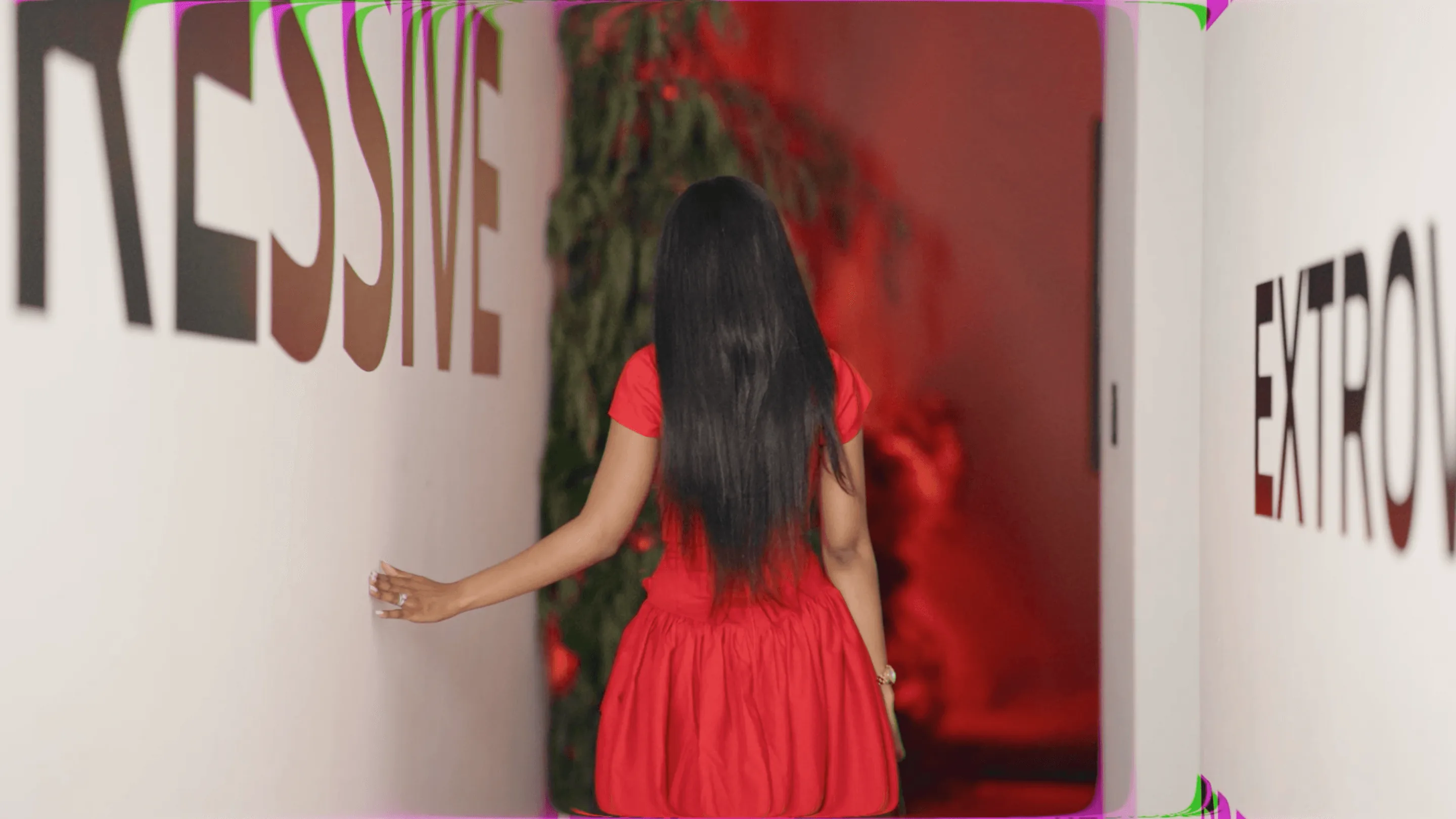 A guest in a red dress viewing the BMW XM x Rich Mnisi installation