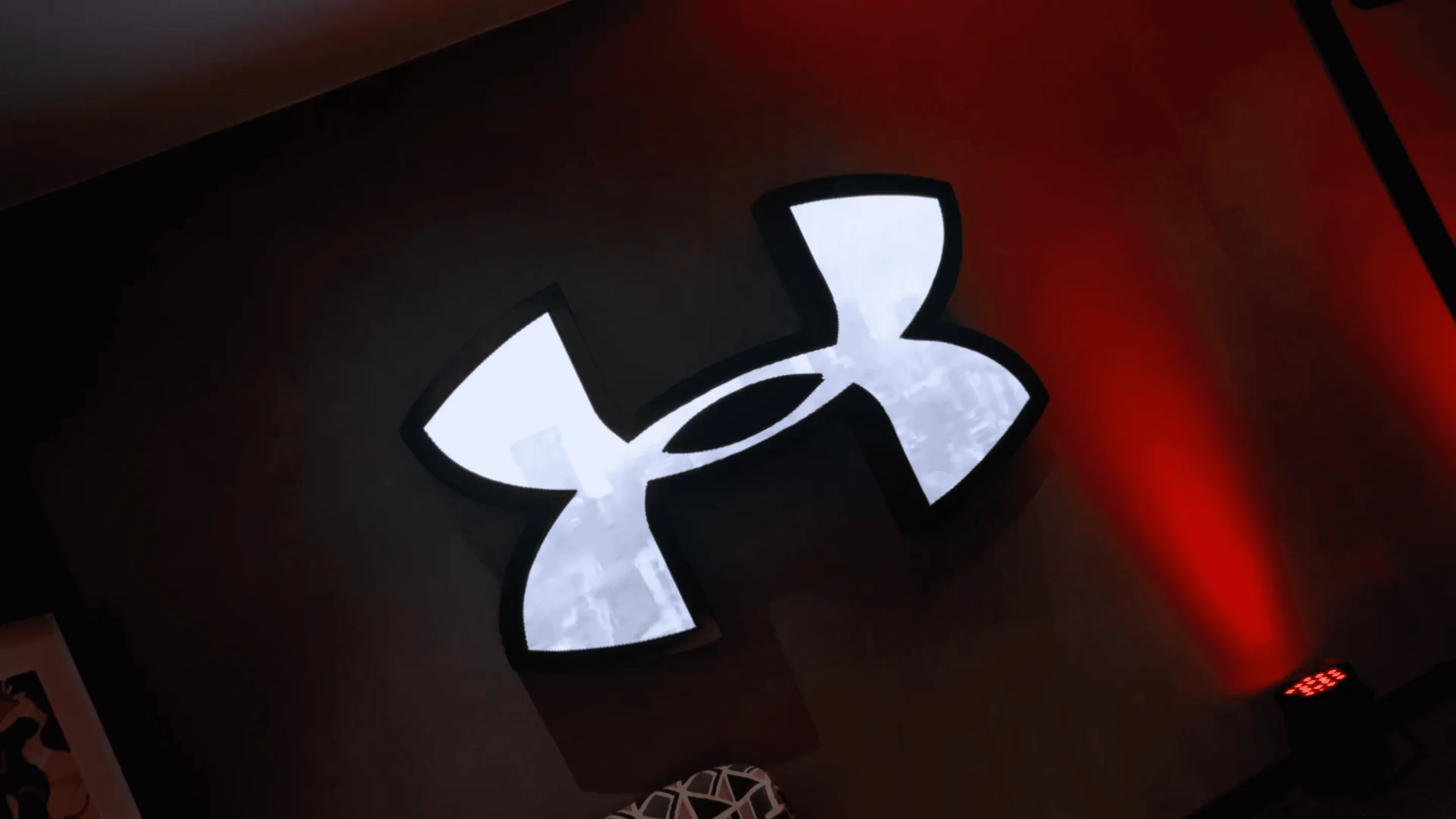 The Under Armour logo lit up at the Sandton City store launch
