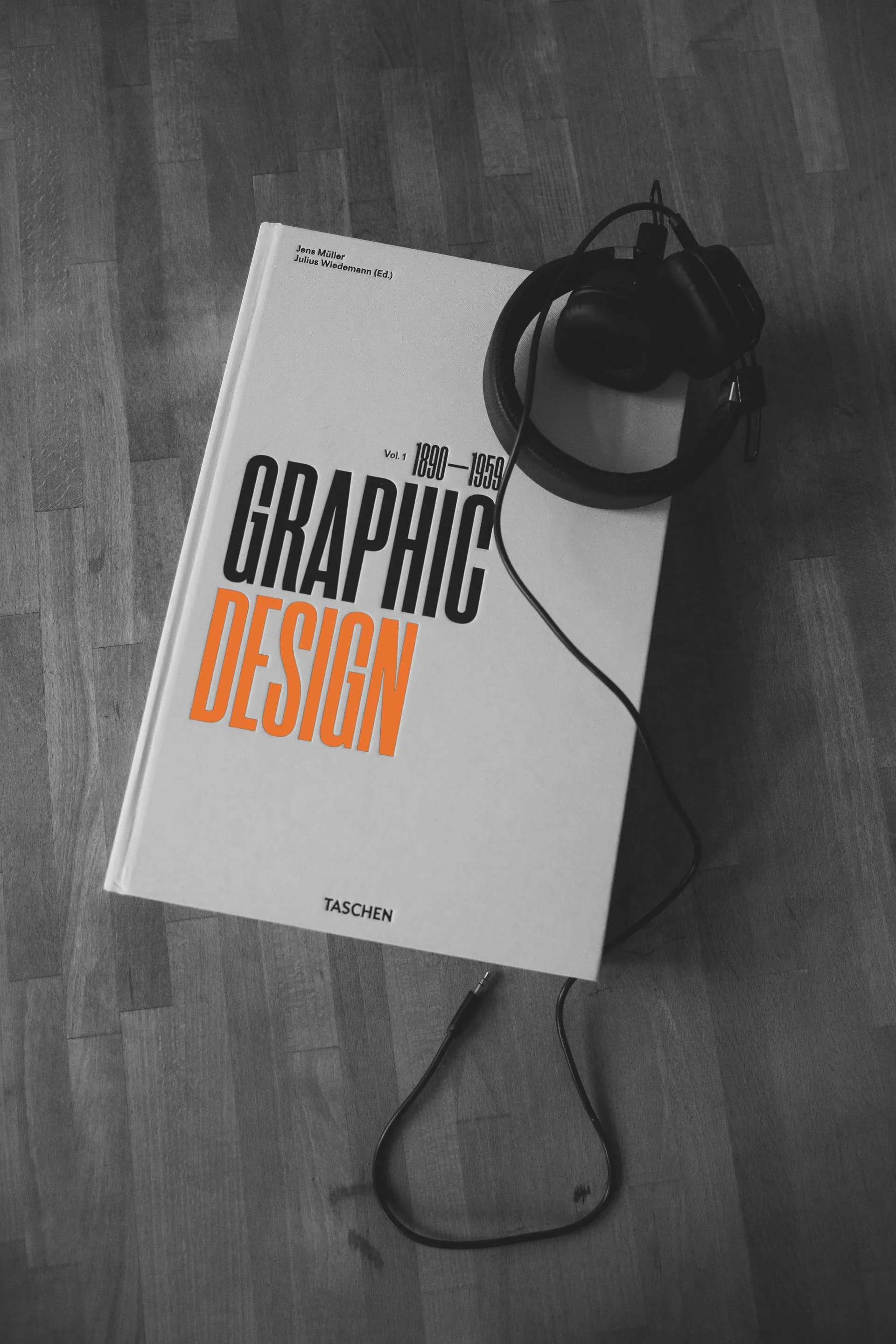 A graphic design book on a dark surface
