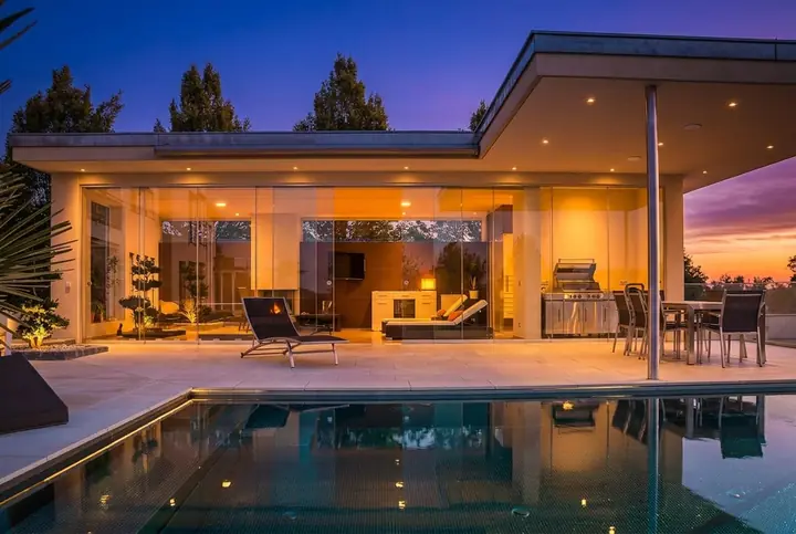 A pool house at dusk, edited from a daylight photo by Twilight